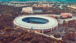 Coppa Italia A stunning aerial image showcasing the iconic Stadio Olimpico surrounded by lush greenery in Rome, Italy.